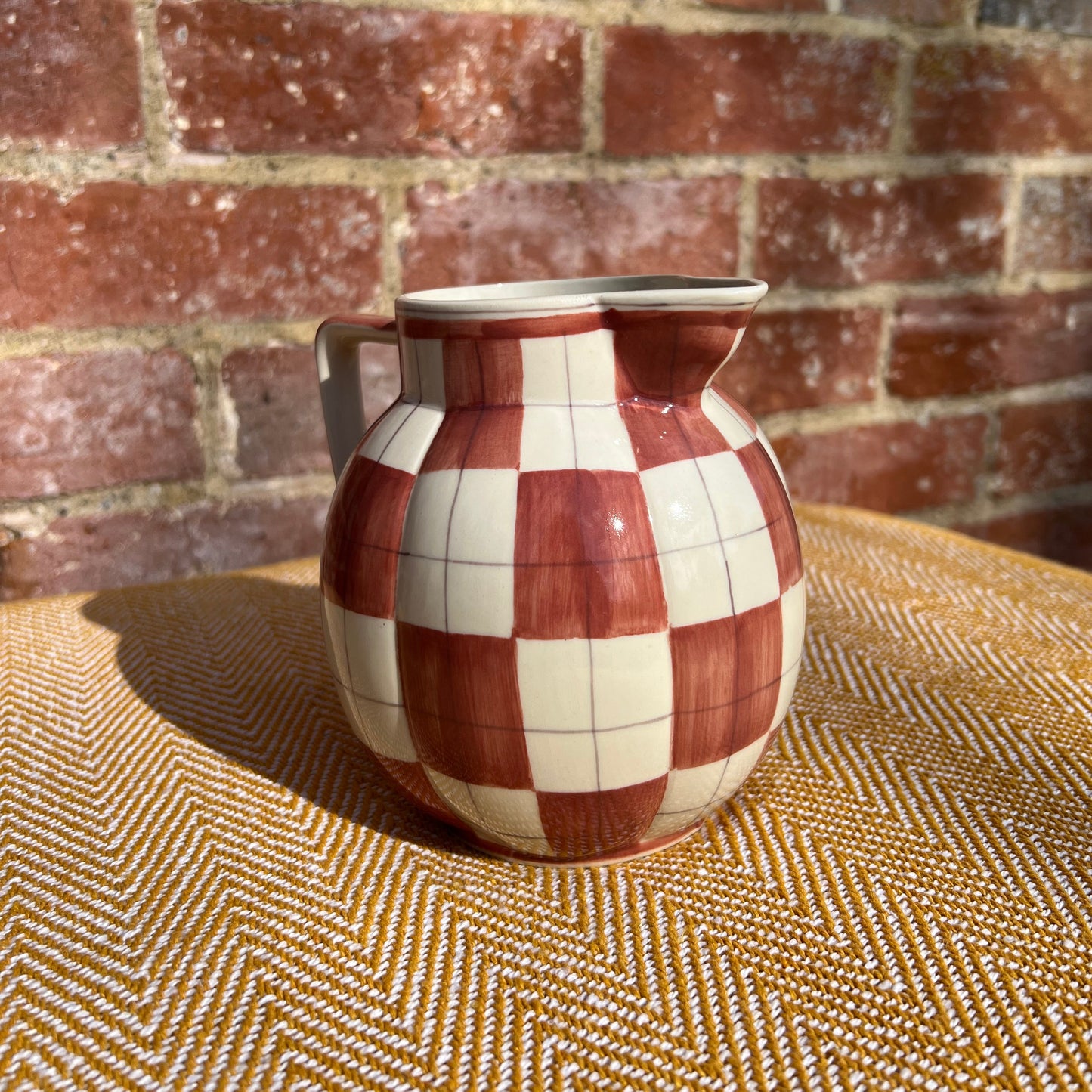 Checkered ceramic pitcher