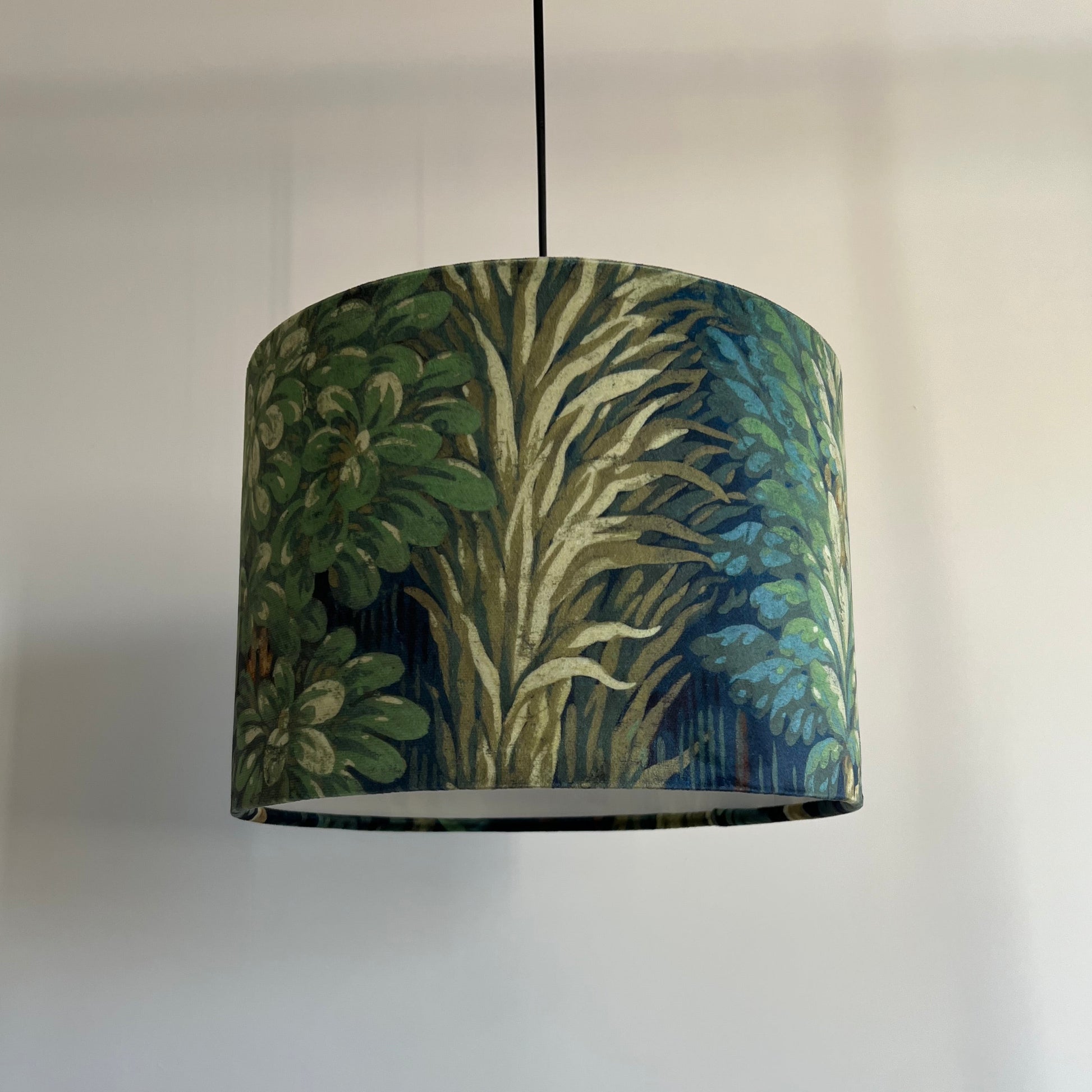 Decorative lampshade with nature-themed design on a plain background